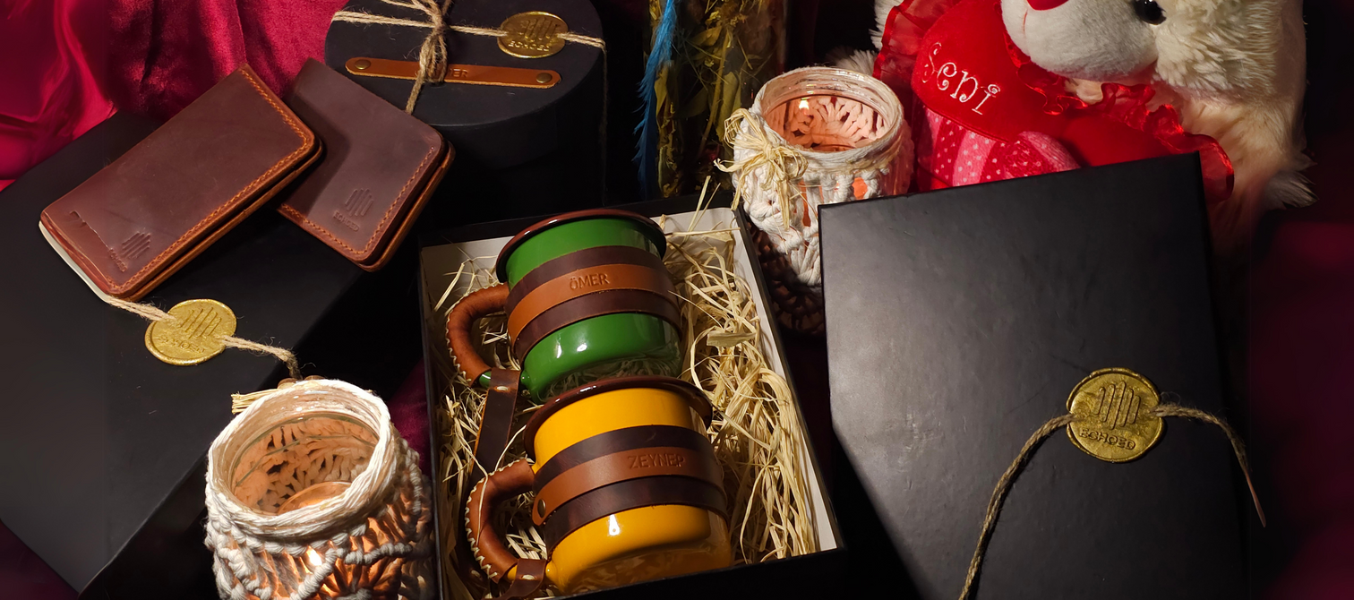 Echoed personalized leather wallet, card holder and leather-wrapped enamel mugs arranged in a black gift box