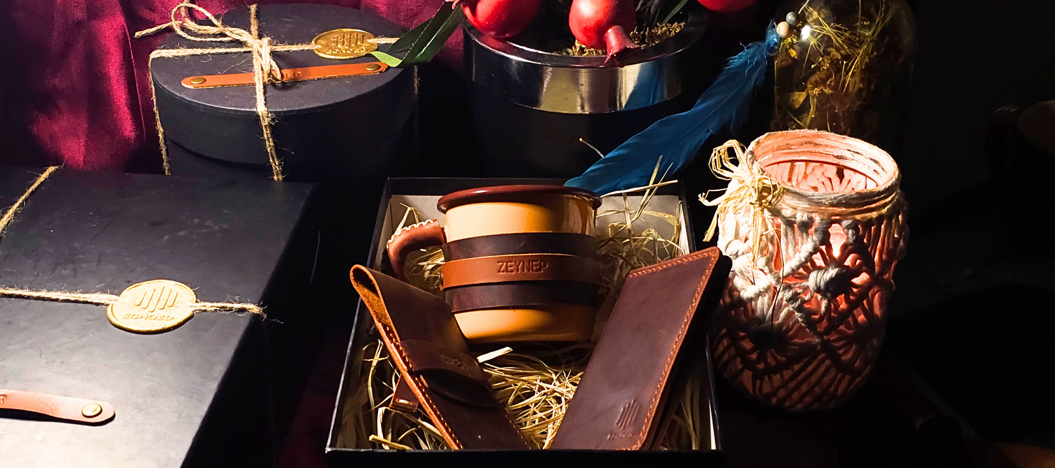 Echoed gift box with a full-grain leather wallet and a leather-wrapped enamel mug