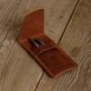 Personalized Full-Grain Leather Pen Case — Alfa, Brown Brown full-grain leather pen case opened on a wooden table with two pens in the pocket